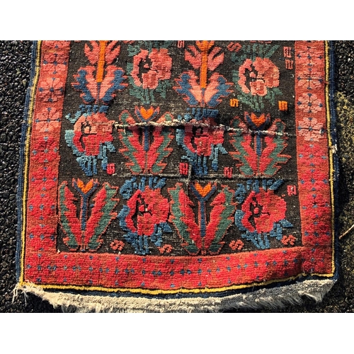 2203 - A small rug on red ground, 92cm wide, 110cm long and another smaller rug 62.5cm wide, 108cm long.