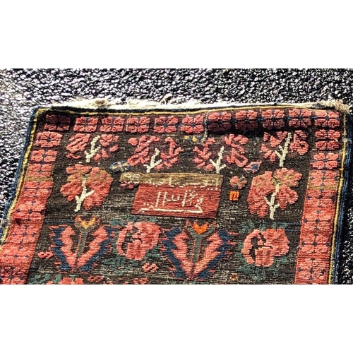 2203 - A small rug on red ground, 92cm wide, 110cm long and another smaller rug 62.5cm wide, 108cm long.