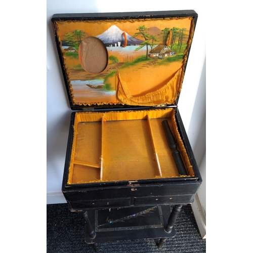 2205 - A circa 19th century black lacquered sewing table, decorated with Oriental scenes, with hinged lid e... 