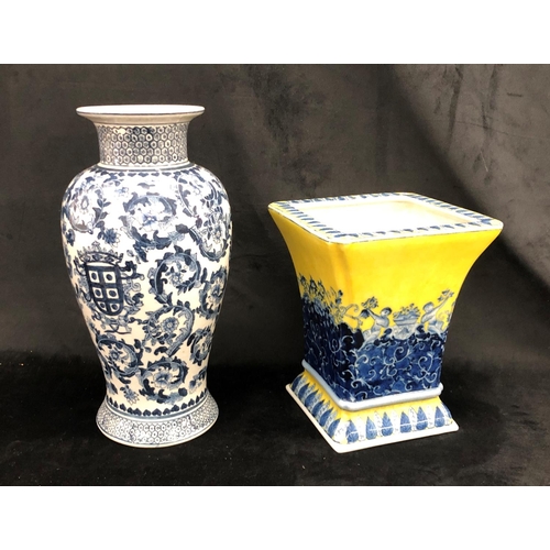 2213 - A reproduction blue and white vase 37cm high and a reproduction blue and yellow vase 25cm high.