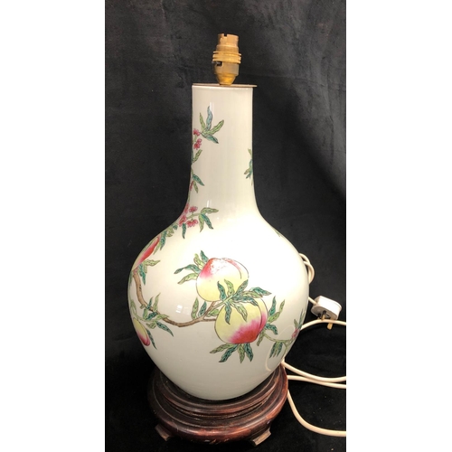 2214 - A glazed china lamp with fruit pattern on wood base, 52.5cm high including bulb fitting.