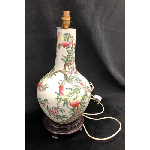 2214 - A glazed china lamp with fruit pattern on wood base, 52.5cm high including bulb fitting.