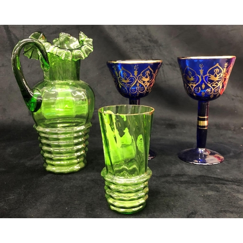 2223 - A Victorian Mary Gregory jug and glass and a pair of Bristol blue goblets with gilt decoration.