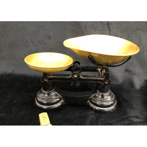 2245 - A set of weighing scales with 7 brass weights, 28cm wide, 21cm high overall.