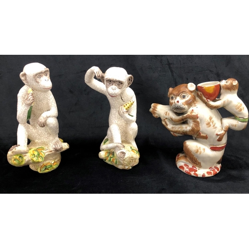 2251 - A pair of china monkeys sitting on branches, 27cm high overall and another figure of a monkey with 2... 