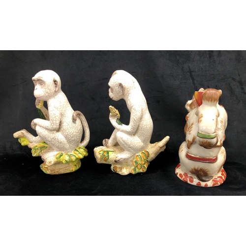 2251 - A pair of china monkeys sitting on branches, 27cm high overall and another figure of a monkey with 2... 