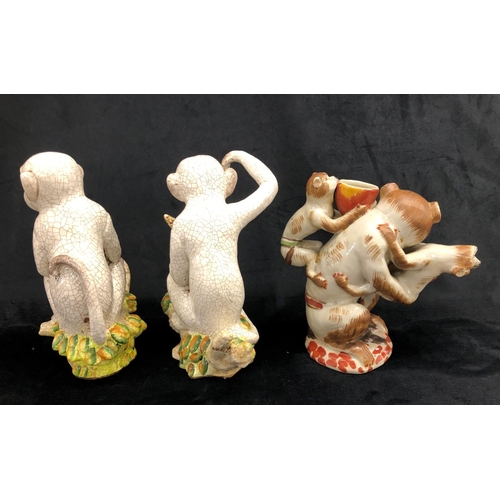 2251 - A pair of china monkeys sitting on branches, 27cm high overall and another figure of a monkey with 2... 