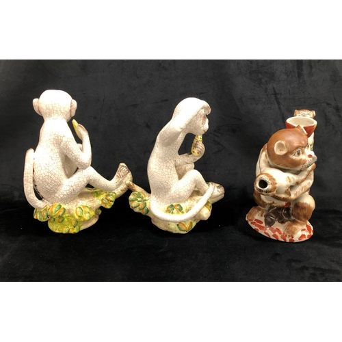 2251 - A pair of china monkeys sitting on branches, 27cm high overall and another figure of a monkey with 2... 