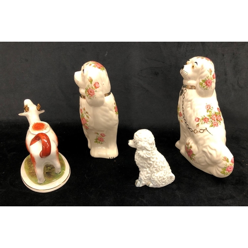 2274 - A pair of Staffordshire dogs on cream ground with rose pattern, 20.5cm high, a white poodle figure, ... 