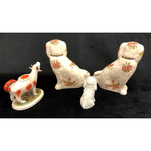 2274 - A pair of Staffordshire dogs on cream ground with rose pattern, 20.5cm high, a white poodle figure, ... 