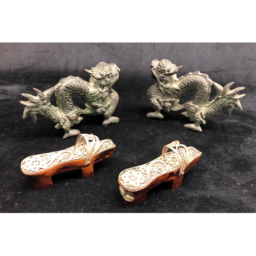 2292 - A pair of bronze Oriental dragons, 13.5cm wide, 9cm high and a pair of Oriental miniature clogs.