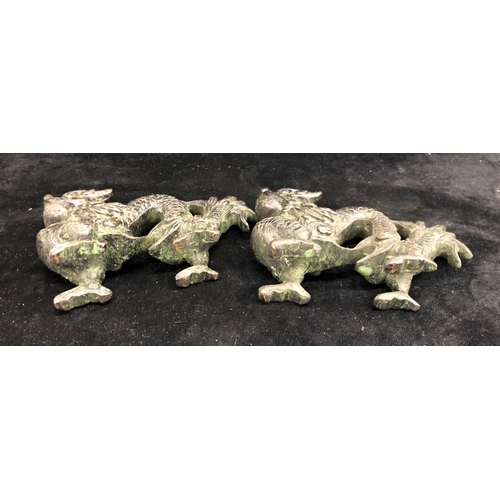 2292 - A pair of bronze Oriental dragons, 13.5cm wide, 9cm high and a pair of Oriental miniature clogs.