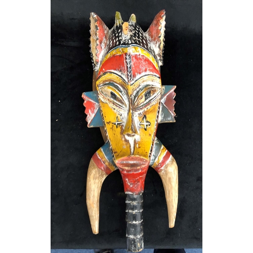 2297 - A wooden painted African style mask, 46cm long, an African wooden carved paperweight, 21.5cm long an... 