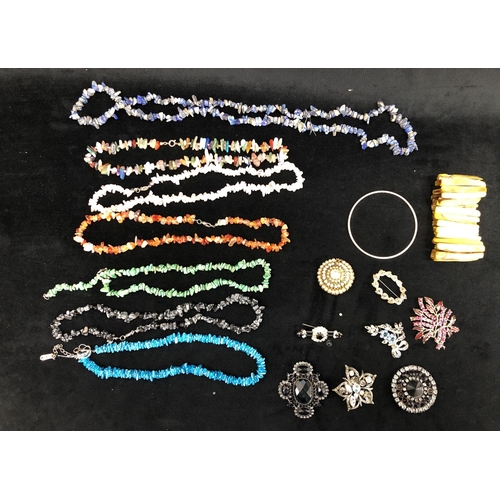 2299 - A quantity of costume jewellery including necklaces, brooches and 2 bracelets.