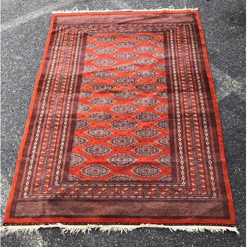 2311 - A rug on red ground, 127.5cm wide, 1914cm long.