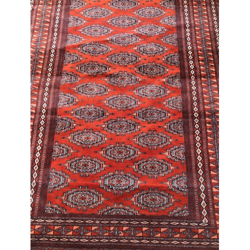 2311 - A rug on red ground, 127.5cm wide, 1914cm long.