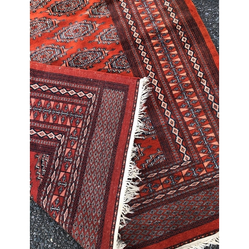 2311 - A rug on red ground, 127.5cm wide, 1914cm long.