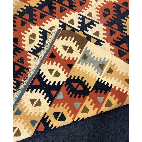 2312 - A kelim rug with multi-coloured geometric design, 115cm wide, 189cm long.