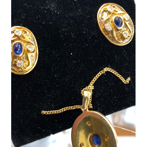 516 - An 18ct gold oval drop pendant with chain and a pair of matching oval earrings, all set with centre ... 