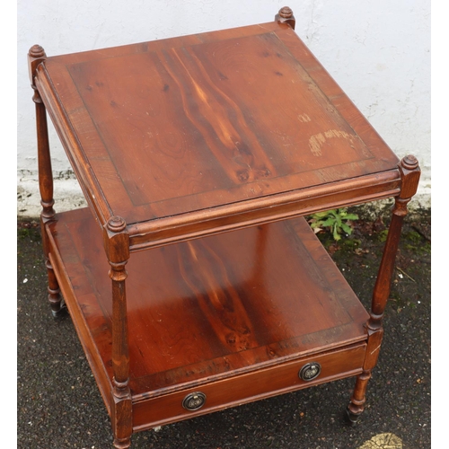 3086 - A reproduction yew 2-tiered occasional table with small drawer and brass handles, on castors 45 x45c... 