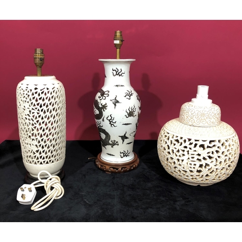 3097 - A china round bulbous thin necked trumpet shaped table lamp on white and black ground with dragon an... 