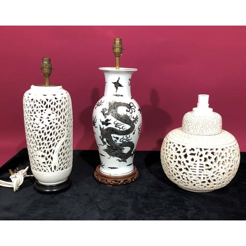 3097 - A china round bulbous thin necked trumpet shaped table lamp on white and black ground with dragon an... 