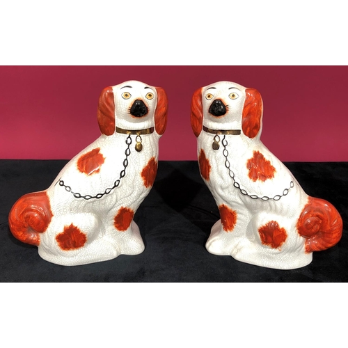 3101 - A pair of reproduction Staffordshire style dogs, 22cm high.