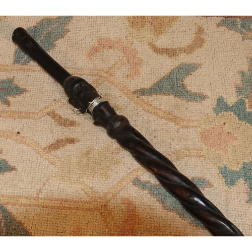 3125 - An ebonised African tribal stick 92cm long. (This item is not held by PF Windibank - please call pri... 