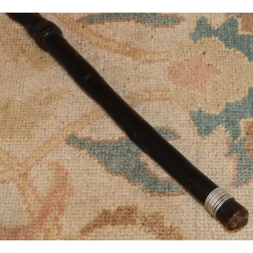 3125 - An ebonised African tribal stick 92cm long. (This item is not held by PF Windibank - please call pri... 