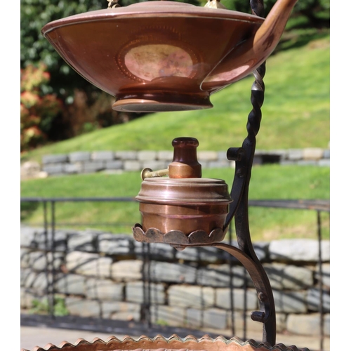 3135 - A metallic stand, 122cm high with hook, with a copper and brass hanging kettle, burner below, 1 circ... 