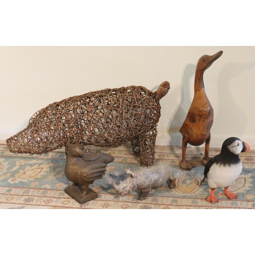 3154 - A large wicker pig, 72cm long, a wooden duck, a composition rhinoceros, a composition puffin bird  a... 