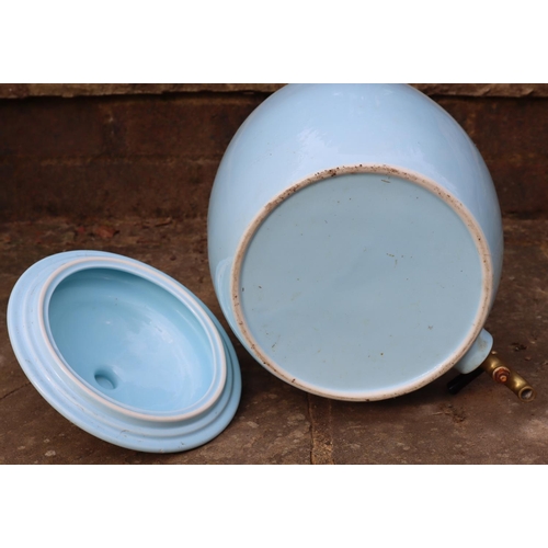 3176 - A light blue ceramic water container with lid and brass tap, 139cm high overall. (This item is not h... 