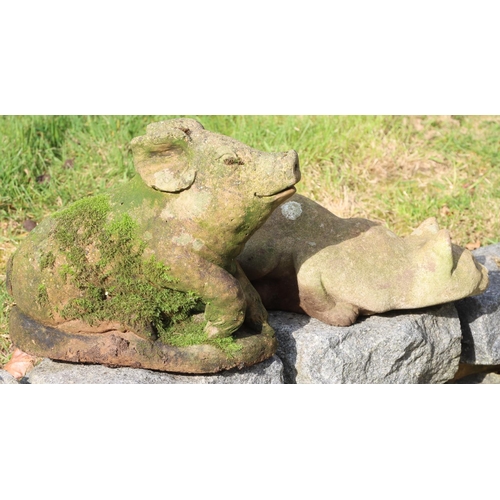 3194 - A stone garden cat ornament, 40cm long overall and a similar pig ornament, 36cm long, 28cm high. (Th... 