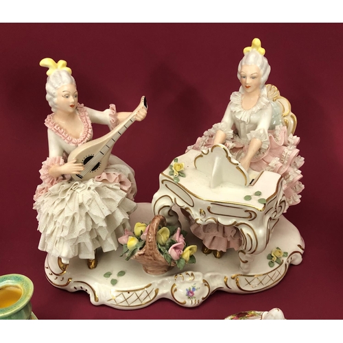 3224 - A German porcelain china group of 2 women playing instruments with encrusted dresses, 21.5cm high ov... 