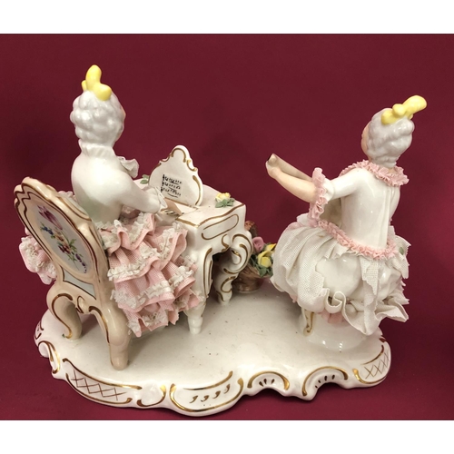 3224 - A German porcelain china group of 2 women playing instruments with encrusted dresses, 21.5cm high ov... 