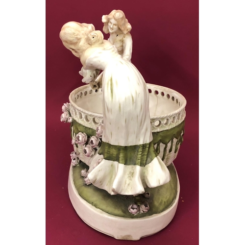 3232 - An Art Nouveau style jardiniere in the form of 2 females holding flower, 45cm wide, 34cm high.