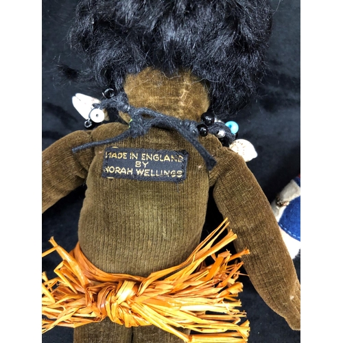 3239 - A Norah Wellings African doll wearing a grass skirt, 22cm long and a similar guardsman doll. (2)