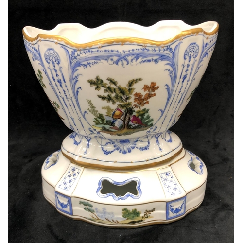 3241 - A reproduction jardiniere on white and blue ground and multi-coloured bird, tree and gilt decoration... 