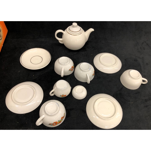 3265 - A child's tea set on white ground with floral pattern, 4 cups, 4 saucers, teapot, sugar bowl and mil... 