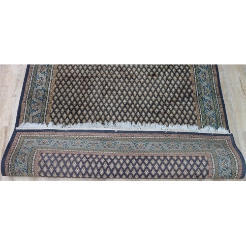 3119 - A black, grey, green, cream and red rug, 173cm wide, 252cm long. (This item is not held by PF Windib... 