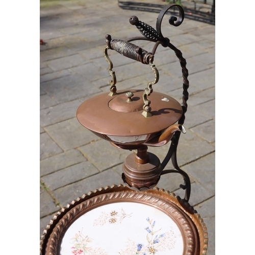 3135 - A metallic stand, 122cm high with hook, with a copper and brass hanging kettle, burner below, 1 circ... 