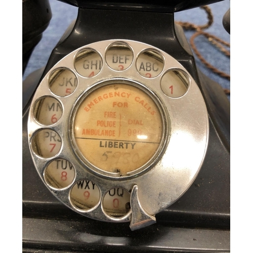 3210 - A black Bakelite telephone.