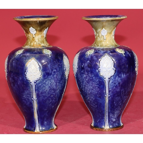 101 - A pair of Royal Doulton glazed earthenware round bulbous thin necked trumpet shaped vases on blue an... 