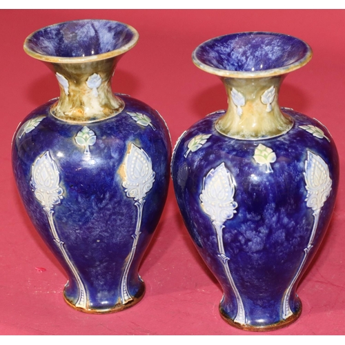 101 - A pair of Royal Doulton glazed earthenware round bulbous thin necked trumpet shaped vases on blue an... 