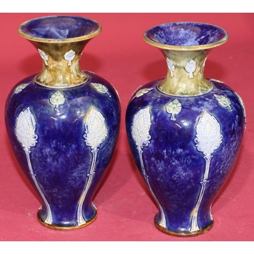 101 - A pair of Royal Doulton glazed earthenware round bulbous thin necked trumpet shaped vases on blue an... 