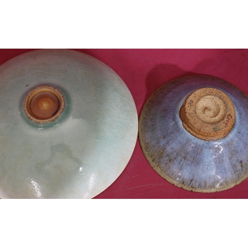 104 - A studio glazed earthenware shallow round bowl on green and red ground, 27cm wide and another simila... 