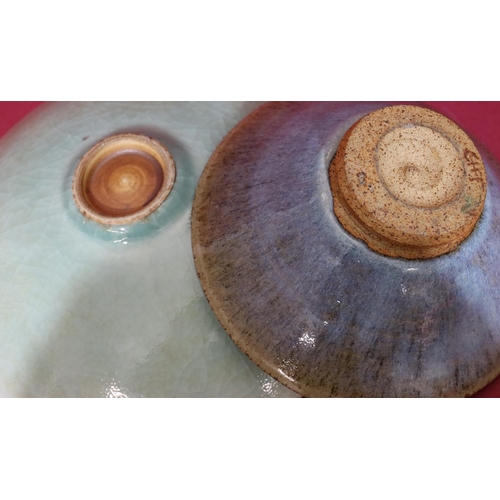 104 - A studio glazed earthenware shallow round bowl on green and red ground, 27cm wide and another simila... 