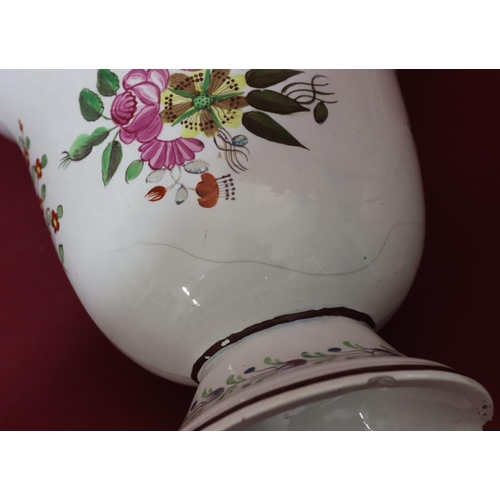 106 - A Creamware oval trumpet shaped 2-handled vase with hand painted multi-coloured floral and leaf deco... 