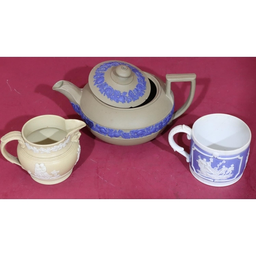 107 - A Wedgwood Jasperware teapot with raised blue floral and leaf decoration (spout and lid chipped), a ... 