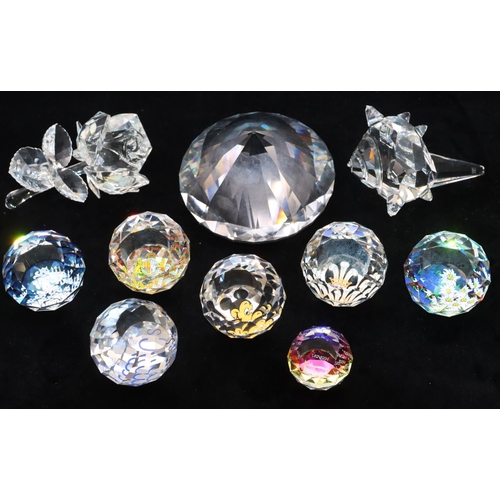 117 - 7 Swarovski crystal round bulbous shaped paperweights, all with multi-coloured inner decoration, a S... 